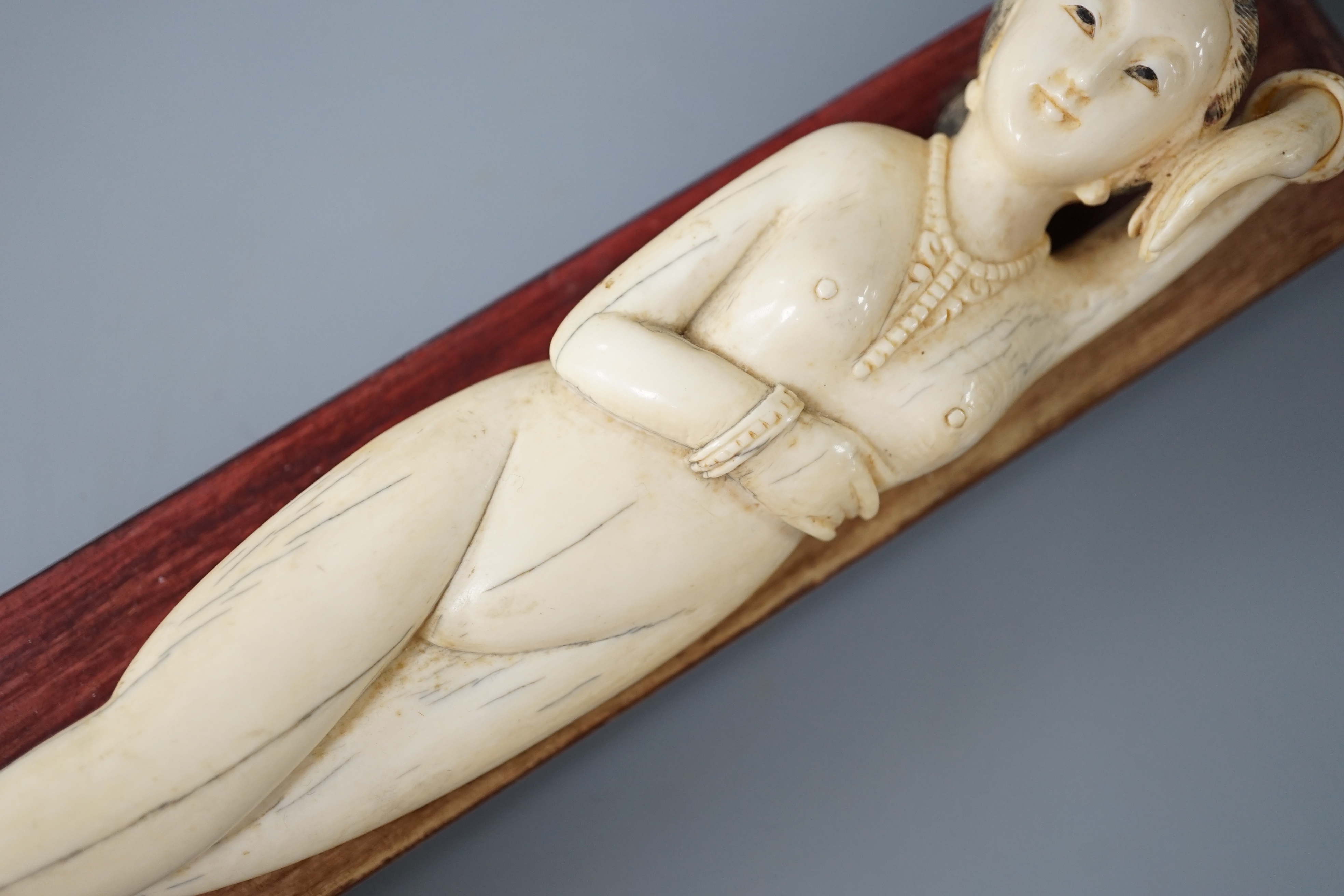 A Chinese carved ivory medicine figure, late 19th/early 20th century, wood stand. 25cm excl stand
